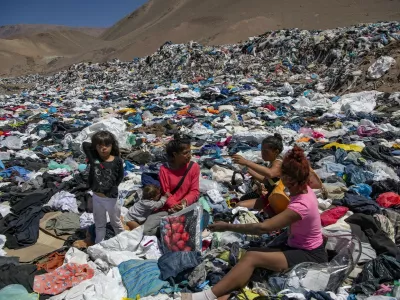 Women search for used clothes amid tons discarded in the Atacama desert, in Alto Hospicio, Iquique, Chile, on September 26, 2021. EcoFibra, Ecocitex and Sembra are circular economy projects that have textile waste as their raw material. The textile industry in Chile will be included in the law of Extended Responsibility of the Producer (REP), forcing clothes and textiles importers take charge of the waste they generate.,Image: 642069771, License: Rights-managed, Restrictions: TO GO WITH AFP STORY BY PAULA BUSTAMANTE, Model Release: no