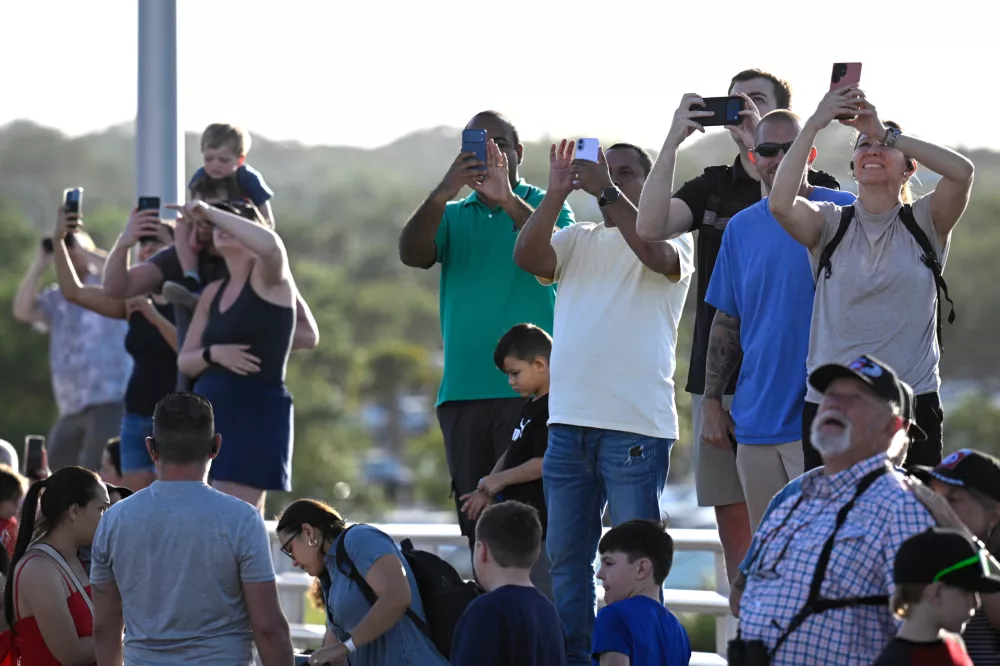 Spectators view NASA's Artemis II moon rocket launch from the A. Max Brewer Bridge, Wednesday, April 1, 2026, in Titusville, Fla. (AP Photo/Phelan M. Ebenhack)