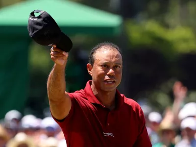 FILE PHOTO: Golf - The Masters - Augusta National Golf Club, Augusta, Georgia, U.S. - April 14, 2024 Tiger Woods of the U.S. acknowledges the crowd on the green on the 18th hole after completing his final round REUTERS/Mike Blake/File Photo