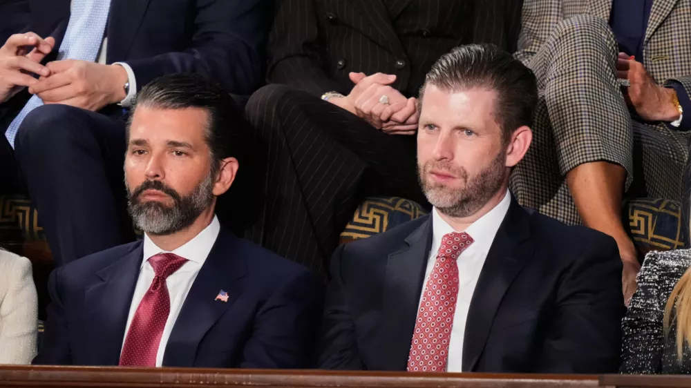 FILE - Donald Trump Jr. and Eric Trump listen to President Donald Trump's State of the Union address at the U.S. Capitol in Washington, Feb. 24, 2026. (AP Photo/Alex Brandon, file)