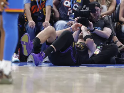 Apr 2, 2026; Oklahoma City, Oklahoma, USA; Los Angeles Lakers guard Luka Doncic (77) falls to the court during a play against the Oklahoma City Thunder during the third quarter at Paycom Center. Mandatory Credit: Alonzo Adams-Imagn Images
