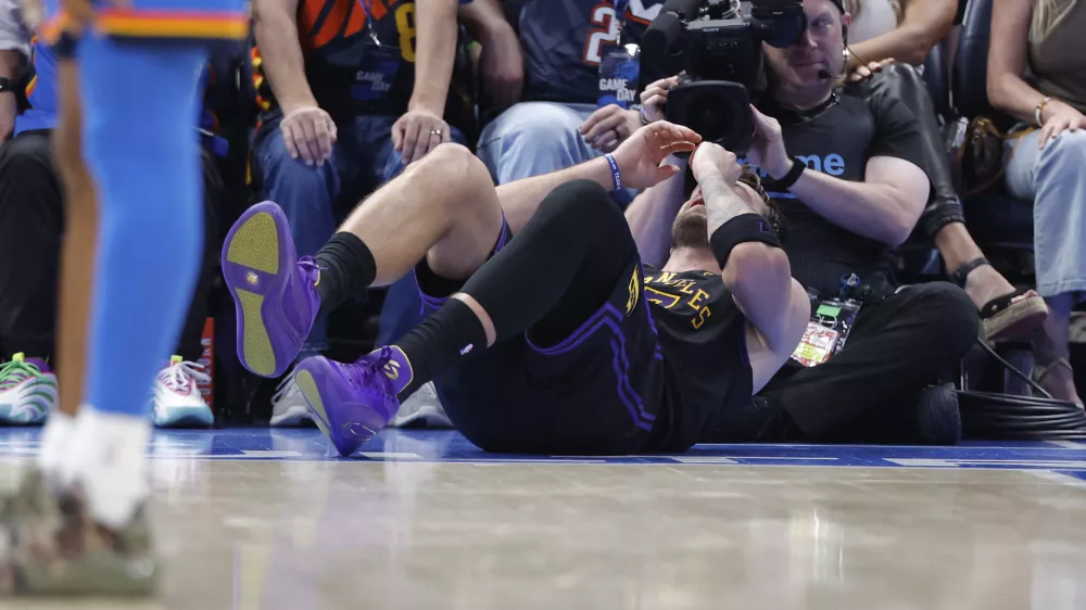 Apr 2, 2026; Oklahoma City, Oklahoma, USA; Los Angeles Lakers guard Luka Doncic (77) falls to the court during a play against the Oklahoma City Thunder during the third quarter at Paycom Center. Mandatory Credit: Alonzo Adams-Imagn Images