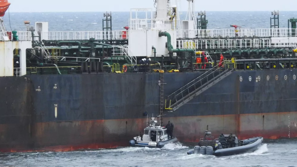 In this photo provided by the Swedish Coast Guard, personnel board a tanker suspected of causing an oil spill in the Baltic Sea, Friday, April 3, 2026. (Swedish Coast Guard via AP)