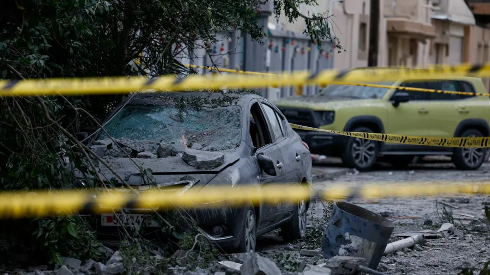 A wrecked car near damaged buildings at the site of an impact of what Bahrain's Ministry of Interior (MOI) said was falling debris of an intercepted Iranian drone last night, amid the U.S.-Israeli conflict with Iran, in Sitra, Bahrain, April 4, 2026. REUTERS/Hamad I Mohammed   TPX IMAGES OF THE DAY