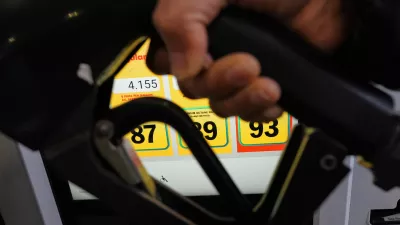A person fills up her vehicle's gas tank at a gas station in Buffalo Grove, Ill., Thursday, April 2, 2026. (AP Photo/Nam Y. Huh)