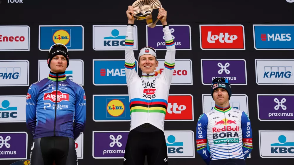 Slovenia's Tadej Pogacar celebrates after winning the Tour of Flanders cycling race, with Netherland's Mathieu Van Der Poel, left, finishing second and Belgium's Remco Evenpoel third in Oudenaarde, Belgium Sunday, April 5, 2026. (AP Photo/Geert Vanden Wijngaert)