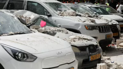 Debris lies on damaged cars at an impact site, following a barrage of missiles launched from Iran, amid the U.S.-Israeli conflict with Iran, in central Israel, April 6, 2026. REUTERS/Nir Elias