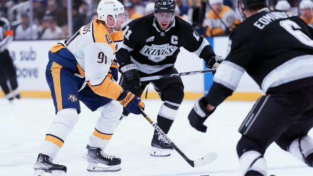 Nashville Predators' center Steven Stamkos (91) brings the puck up ice against Los Angeles Kings' center Anze Kopitar (11) during the third period of an NHL hockey game Monday, April 6, 2026, in Los Angeles. (AP Photo/Scott Strazzante)