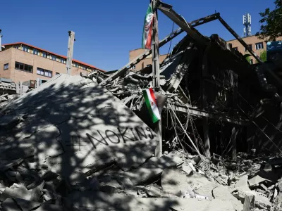 An Iranian flag hangs amidst the rubble of a building of the Sharif University of Technology, which was damaged in a strike, amid the U.S.-Israeli conflict with Iran, in Tehran, Iran, April 7, 2026. Majid Asgaripour/WANA (West Asia News Agency) via REUTERS ATTENTION EDITORS - THIS PICTURE WAS PROVIDED BY A THIRD PARTY