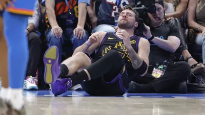 Apr 2, 2026; Oklahoma City, Oklahoma, USA; Los Angeles Lakers guard Luka Doncic (77) falls to the court during a play against the Oklahoma City Thunder during the third quarter at Paycom Center. Mandatory Credit: Alonzo Adams-Imagn Images