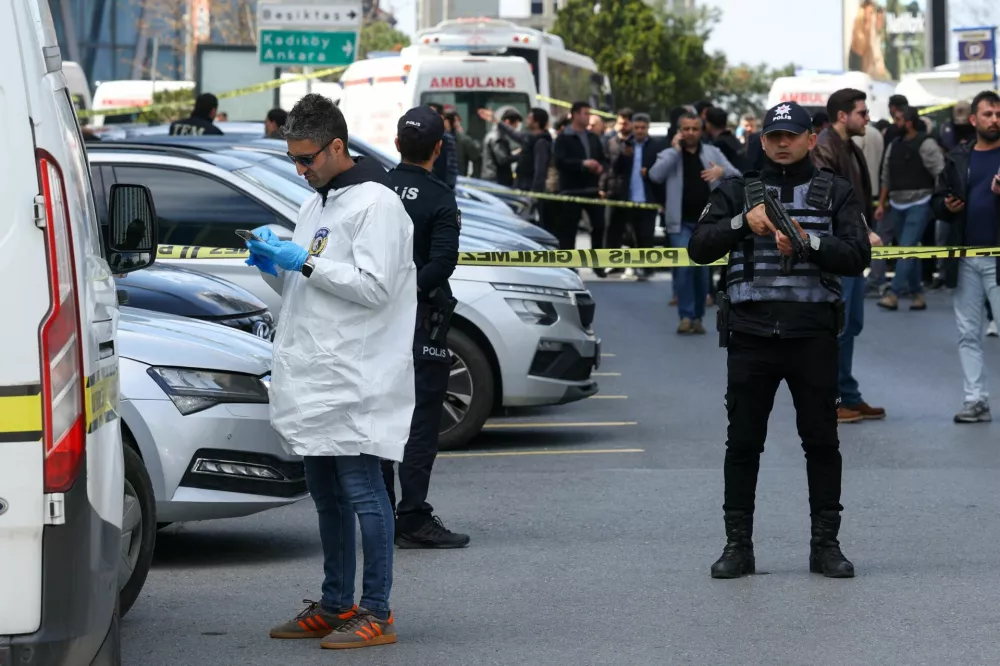 A forensic expert arrives at the scene, after gunfire was heard near the building housing the Israeli consulate, according to a witness, in Istanbul, Turkey, April 7, 2026. REUTERS/Murad Sezer