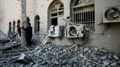 People stand amidst the rubble of a building of the Sharif University of Technology, which was damaged in a strike, amid the U.S.-Israeli conflict with Iran, in Tehran, Iran, April 7, 2026. Majid Asgaripour/WANA (West Asia News Agency) via REUTERS ATTENTION EDITORS - THIS PICTURE WAS PROVIDED BY A THIRD PARTY   TPX IMAGES OF THE DAY