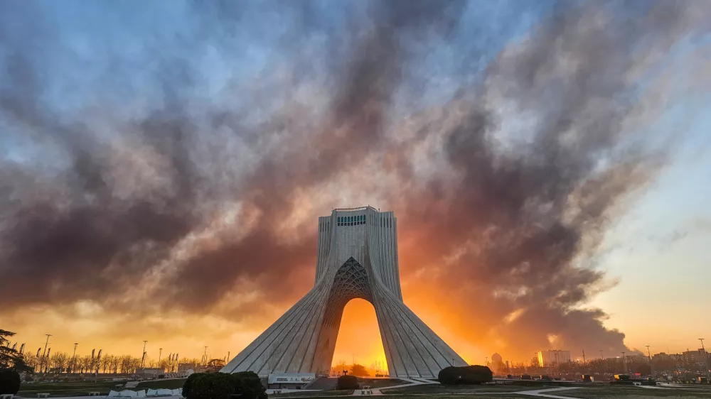 FILE - Smoke rises behind the Azadi (Freedom) monument in Tehran, Iran, on March 3, 2026, following the U.S.-Israeli military attack. (Davoud Ghahrdar/ISNA via AP, File)