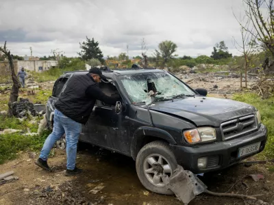 Hussein Saleh, 34, takes out documents from his car near the rubble of his house destroyed in an Israeli airstrike, which killed members of his family, amid escalating hostilities between Israel and Hezbollah, as the U.S.-Israeli conflict with Iran continues, in Tyre, Lebanon, April 7, 2026. REUTERS/Adnan Abidi