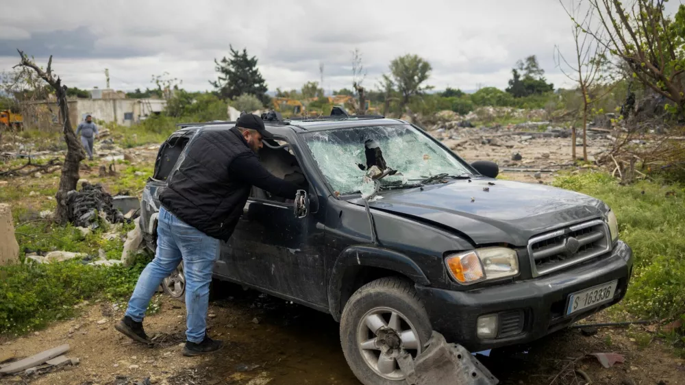 Hussein Saleh, 34, takes out documents from his car near the rubble of his house destroyed in an Israeli airstrike, which killed members of his family, amid escalating hostilities between Israel and Hezbollah, as the U.S.-Israeli conflict with Iran continues, in Tyre, Lebanon, April 7, 2026. REUTERS/Adnan Abidi