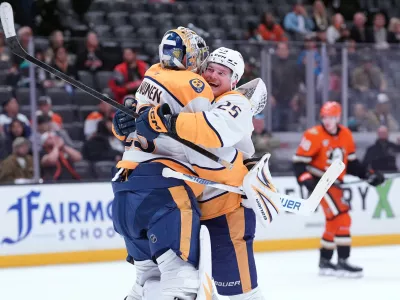 Nashville Predators' right wing Joakim Kemell (25) hugs goaltender Justus Annunen (29) after an NHL hockey game against the Anaheim Ducks, Tuesday, April 7, 2026, in Anaheim, Calif.. (AP Photo/Scott Strazzante)