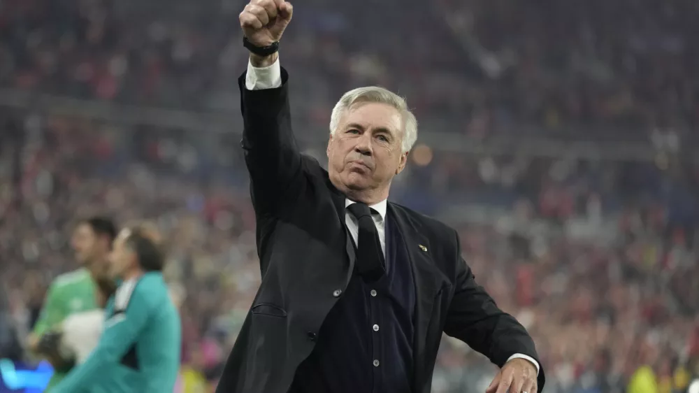 Real Madrid's head coach Carlo Ancelotti celebrates winning the Champions League final soccer match between Liverpool and Real Madrid at the Stade de France in Saint Denis near Paris, Saturday, May 28, 2022. Real Madrid won 1-0. (AP Photo/Kirsty Wigglesworth)