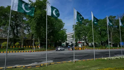 Security officers search a car at the main entrance of Pakistan's foreign ministry to ensure security ahead of the United States and Iran possible negotiations in Pakistani capital after two-week ceasefire, in Islamabad, Pakistan, Thursday, April 9, 2026. (AP Photo/Anjum Naveed)
