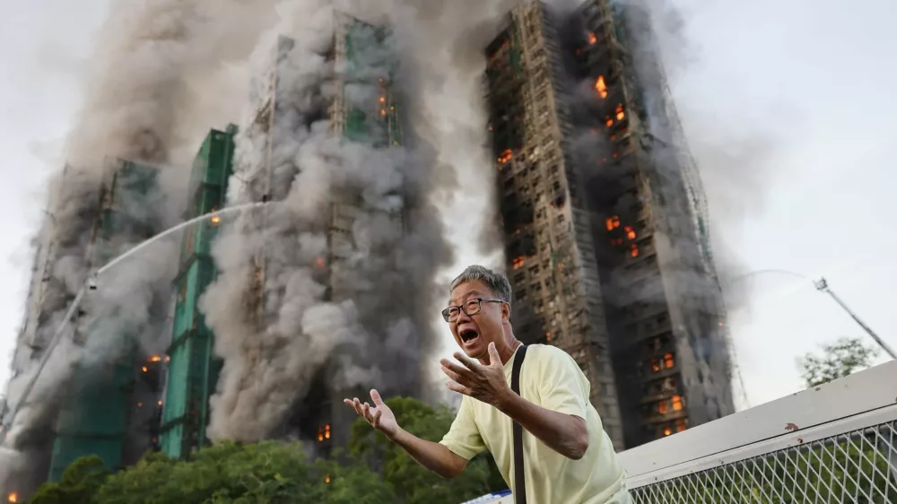 Mr Wong cries out in anguish as fire engulfs the Tai Po housing complex he calls home. Moments earlier, he phoned his wife, who was trapped in the building, and they exchanged what would be their final words. Hong Kong, 26 November 2025 Photograph: Tyrone Siu, Reuters/World Press Photo 2026