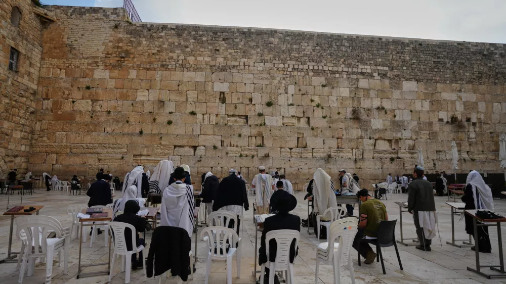 Ultra-Orthodox Jewish men pray at the Western Wall, the holiest site where Jews can pray, after restrictions were lifted following a ceasefire reached between Iran, Israel and the United States, in the Old City of Jerusalem, Thursday, April 9, 2026. (AP Photo/Mahmoud Illean)