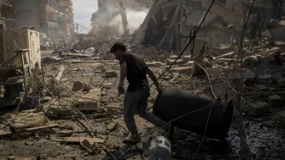 A man pulls a drum at the site of an Israeli strike in Tyre, Lebanon, April 8, 2026. REUTERS/Adnan Abidi   TPX IMAGES OF THE DAY