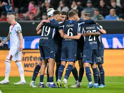 Hoffenheim's Bazoumana Toure celebrates with teammates after scoring during the German Bundesliga soccer match between FC Augsburg and TSG 1899 Hoffenheim in Augsburg, Germany, Friday, April 10, 2026. (Harry Langer/dpa via AP)
