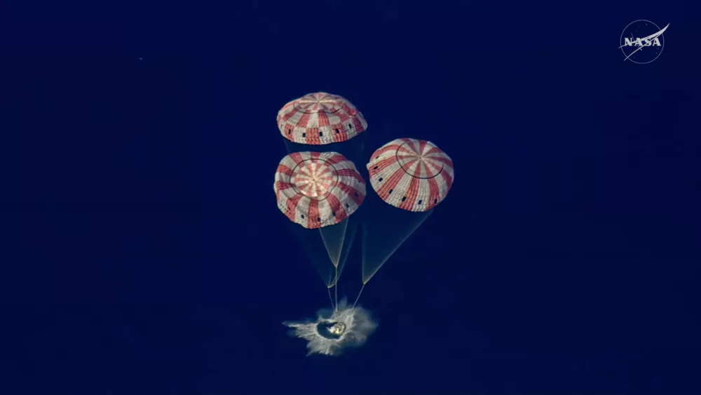 In this image from video provided by NASA, the Artemis II Orion capsule splashes down in the Pacific Ocean, on Friday, April 10, 2026. (NASA via AP)