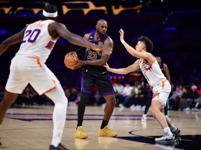 Apr 10, 2026; Los Angeles, California, USA; Los Angeles Lakers forward LeBron James (23) controls the ball against Phoenix Suns guard Koby Brea (14) during the second half at Crypto.com Arena. Mandatory Credit: Gary A. Vasquez-Imagn Images