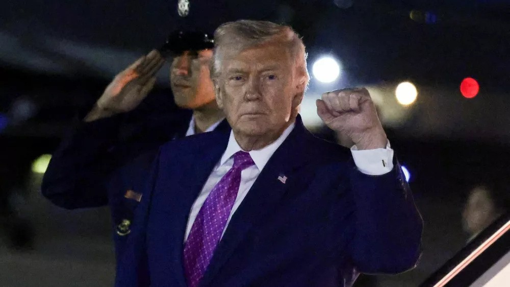 U.S. President Donald Trump gestures after deboarding from Air Force One as he returns from Virginia, at Joint Base Andrews in Maryland, U.S., April 10, 2026. REUTERS/Evelyn Hockstein