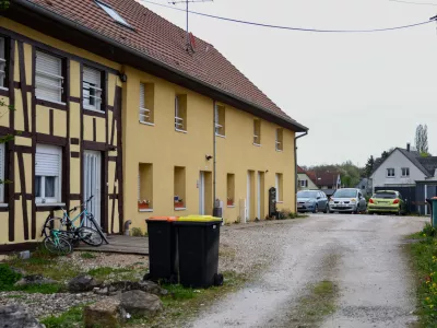 Outside view of the building and the parking area where a 9-year-old boy was rescued after living locked in his father's utility van since 2024, in Hagenbach, Eastern France, Saturday, April 11, 2026. (AP Photo)