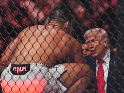 Paulo Costa talks with President Donald Trump after he won his fight by TKO at UFC 327 at Kaseya Center, Saturday, April 11, 2026, in Miami. (AP Photo/Rebecca Blackwell)