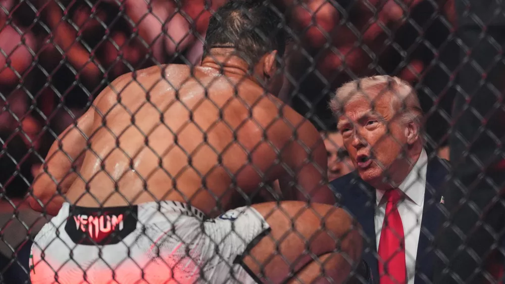 Paulo Costa talks with President Donald Trump after he won his fight by TKO at UFC 327 at Kaseya Center, Saturday, April 11, 2026, in Miami. (AP Photo/Rebecca Blackwell)