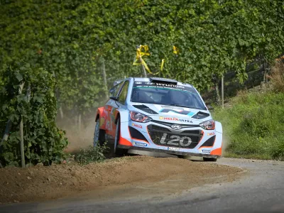 Belgium's Thierry Neuville and his co-driver Nicolas Gilsoul steer the Hyundai through the vineyards during a special stage of the Deutschland Rallye, the German WRC stage, in Neumagen,, Germany, Sunday Aug. 24, 2014. Thierry Neuville held his nerve to win the Rally of Germany after Finland's Jari-Matti Latvala and then Britain's Kris Meeke crashed out of the lead on Sunday. (AP Photo/dpa,Thomas Frey)