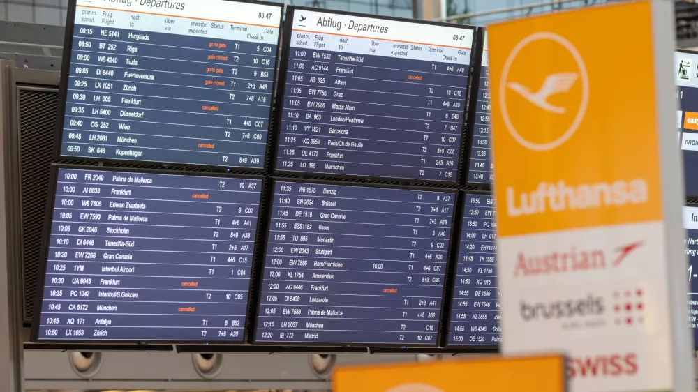 Canceled flights are shown on a display board at the airport in Hamburg, Germany, Friday, April 10, 2026. (Bodo Marks/dpa via AP)