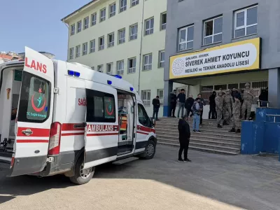 Turkish security forces and emergency staff stand at the courtyard of a high school where an assailant opened fire, in Siverek, south east Turkey, Tuesday, April 14, 2026, (Mevlut Bayraktar/IHA via AP)