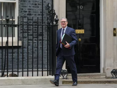 Larry, Chief Mouser to the Cabinet Office sleeps, left, as Britain's Prime Minister Keir Starmer leaves 10 Downing Street to attend the weekly session of Prime Minister's Questions in Parliament in London, Wednesday, April 15, 2026. (AP Photo/Kirsty Wigglesworth)