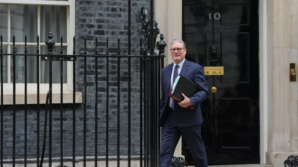 Larry, Chief Mouser to the Cabinet Office sleeps, left, as Britain's Prime Minister Keir Starmer leaves 10 Downing Street to attend the weekly session of Prime Minister's Questions in Parliament in London, Wednesday, April 15, 2026. (AP Photo/Kirsty Wigglesworth)