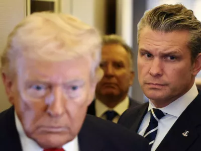 FILE PHOTO: U.S. President Donald Trump, with Secretary of Defense Pete Hegseth at his side, speaks to reporters aboard Air Force One on a flight from Dover, Delaware, to Miami, Florida, U.S., March 7, 2026. REUTERS/Kevin Lamarque/File Photo