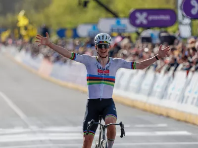 Slovenia's Tadej Pogacar crosses the finish line to win the Tour of Flanders cycling race, in Oudenaarde, Belgium Sunday, April 5, 2026. (AP Photo/Geert Vanden Wijngaert)