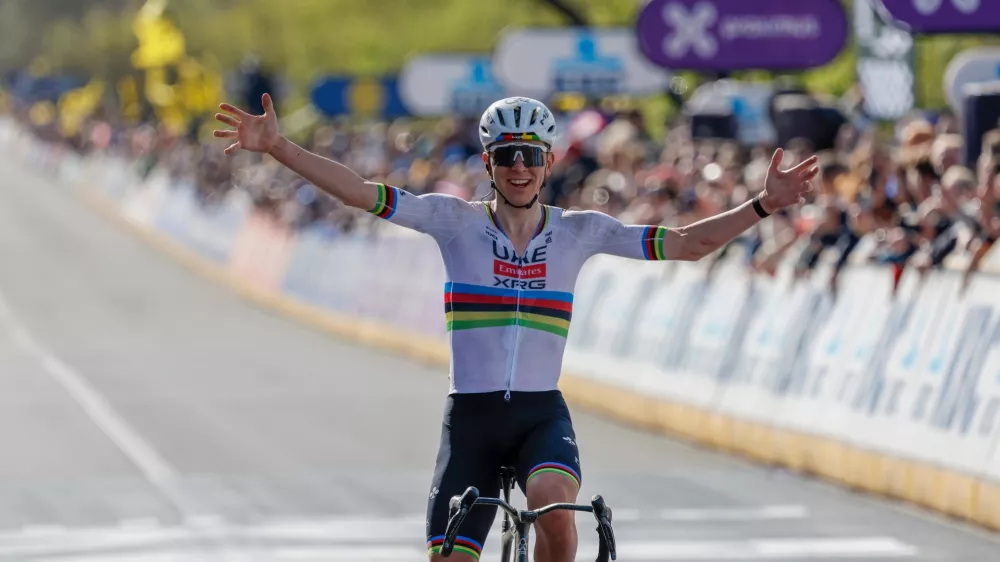 Slovenia's Tadej Pogacar crosses the finish line to win the Tour of Flanders cycling race, in Oudenaarde, Belgium Sunday, April 5, 2026. (AP Photo/Geert Vanden Wijngaert)