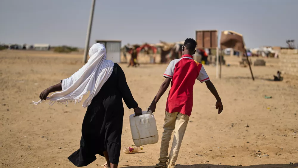 Internally displaced Sudanese people haul water in a container at the Al Heshan camp in Port Sudan, Sudan, Wednesday, April 15, 2026. (AP Photo/Bernat Armangue)