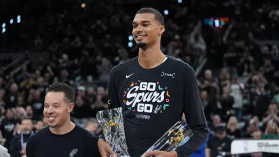 San Antonio Spurs forward Victor Wembanyama, right, stand with head coach Mitch Johnson after receiving his NBA Defensive Player of the Year trophy before Game 2 of a first-round NBA playoffs basketball series in San Antonio, Tuesday, April 21, 2026. (AP Photo/Eric Gay) / Foto: Eric Gay
