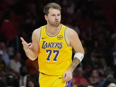 Los Angeles Lakers guard Luka Doncic (77) reacts after scoring during the second half of an NBA basketball game against the Miami Heat, Thursday, March 19, 2026, in Miami. (AP Photo/Lynne Sladky)