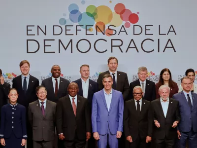 Spain's Prime Minister Pedro Sanchez, center, poses with attendees, at the Meeting in Defence of Democracy summit in Barcelona, Spain, Saturday, April 18, 2026. (AP Photo/Joan Monfort)