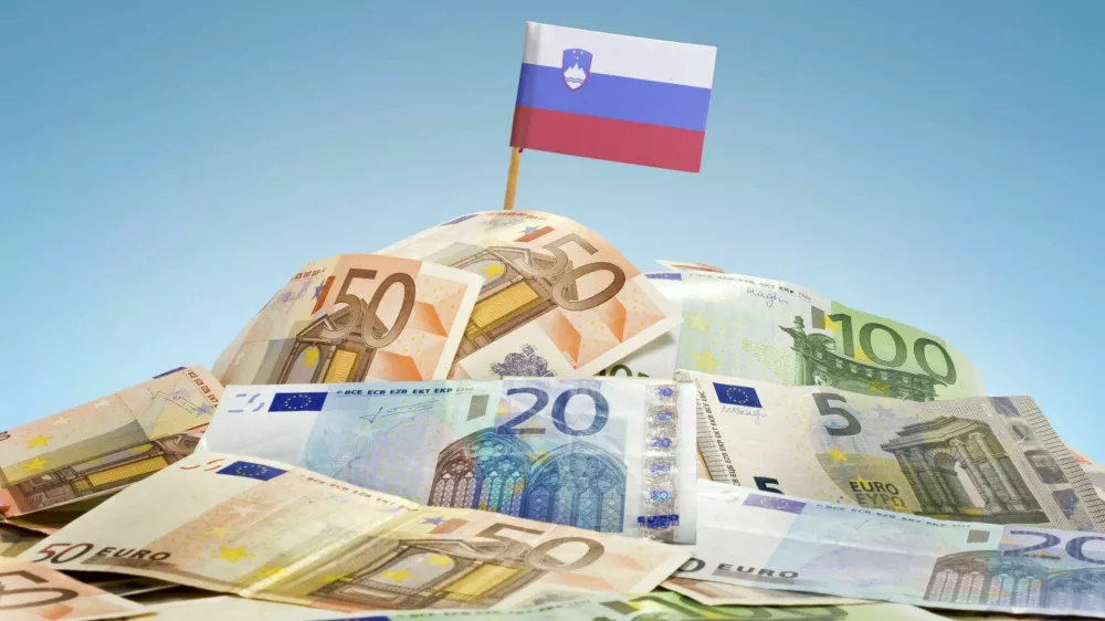 The national flag of Slovenia sticking in a pile of mixed european banknotes.(series)