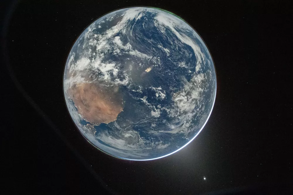 This image provided by NASA shows a view of Earth taken by NASA astronaut and Artemis II Commander Reid Wiseman from of the Orion spacecraft's window after completing the translunar injection burn on April 2, 2026. (NASA via AP)