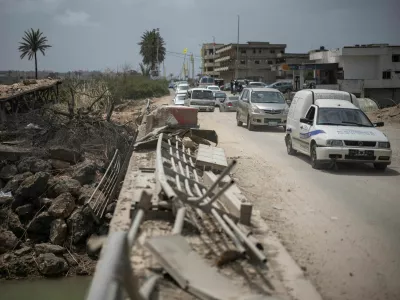 People travel in vehicles as displaced people make their way back to their home crossing the bridge linking southern Lebanon to the rest of the country, which was hit earlier in an Israeli strike, amid a 10-day ceasefire between Lebanon and Israel, in Qasmiyeh, Lebanon, April 19, 2026. REUTERS/Marko Djurica