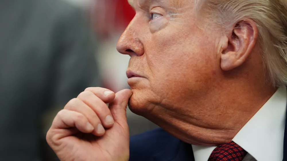 President Donald Trump listens to speeches before signing an executive order in the Oval Office of the White House, Saturday, April 18, 2026, in Washington. (AP Photo/Julia Demaree Nikhinson)