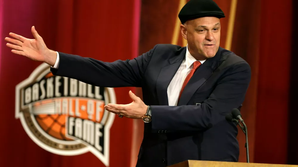 FILE - Inductee Oscar Schmidt, of Brazil, speaks during the enshrinement ceremony for this year's class of the Basketball Hall of Fame, at Symphony Hall in Springfield, Mass., Sept. 8, 2013. Schmidt, whom his Brazil compatriots know as the "Holy Hand," died. Friday, April 17, 2026. He was 68. (AP Photo/Steven Senne, File)