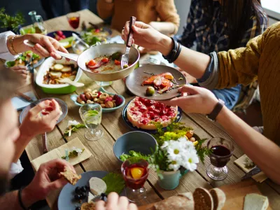 People sitting at dining table and eating